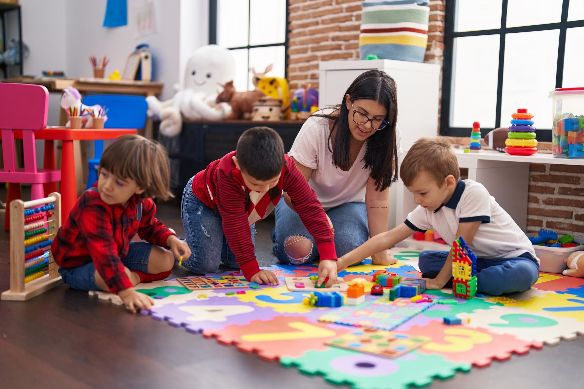 Parents playing with children on a play mat