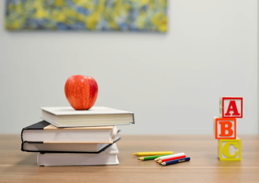 Books with an apple and alphabet blocks