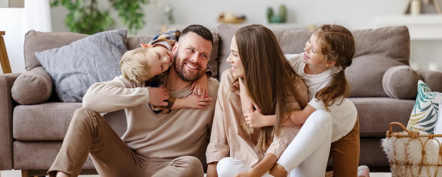 A family relaxing together on a couch at home